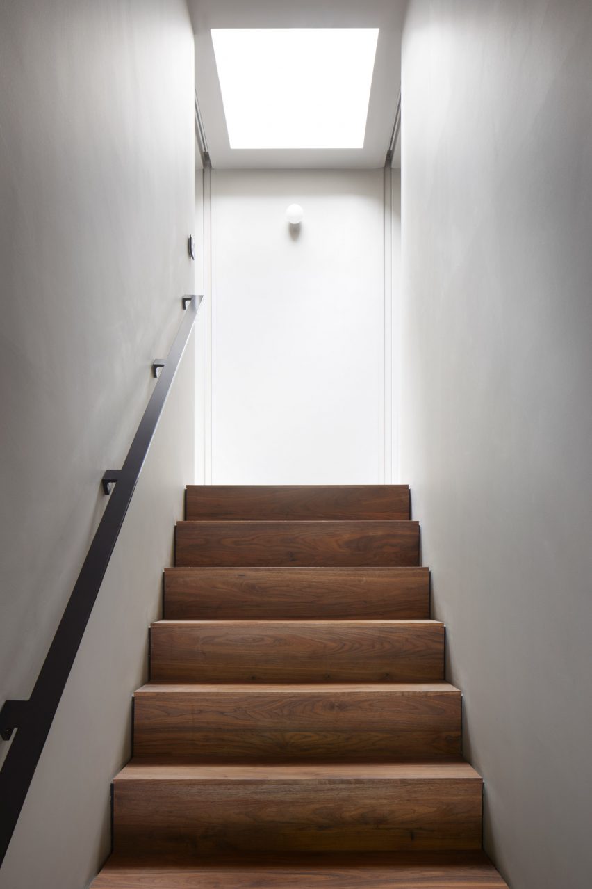 A walnut staircase lit by a skylight in a Scottish house