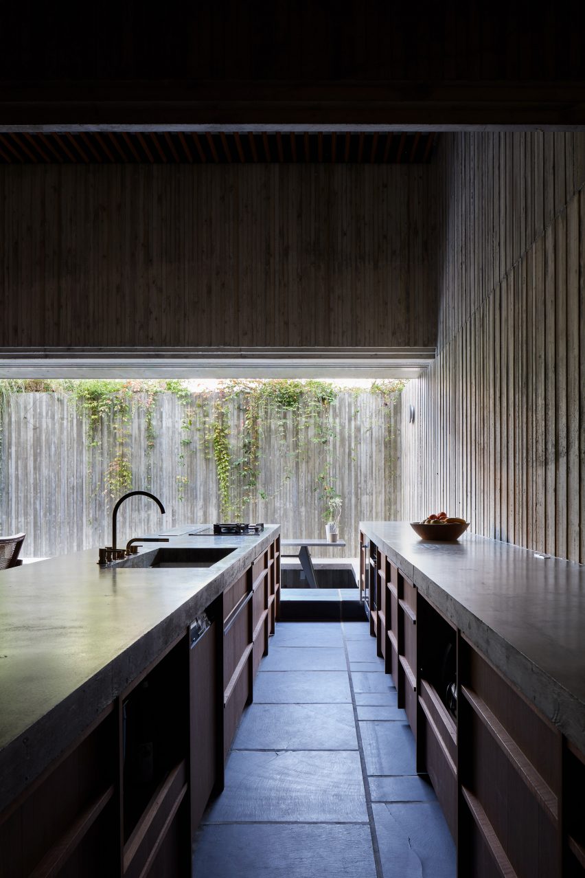 The dark concrete interiors of Japanese kitchen