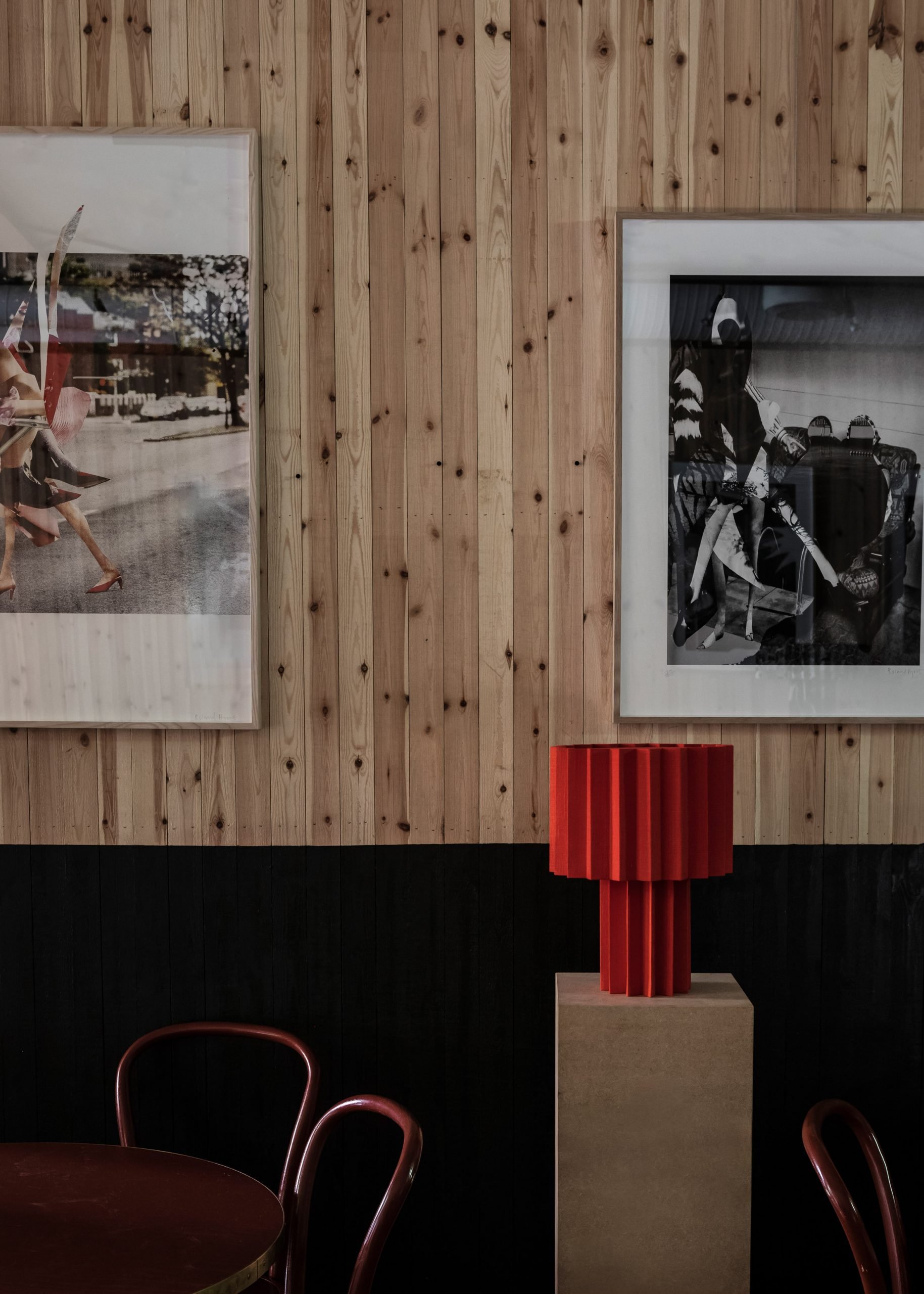 Red pleated lamp and black and white prints by Roland Hjort