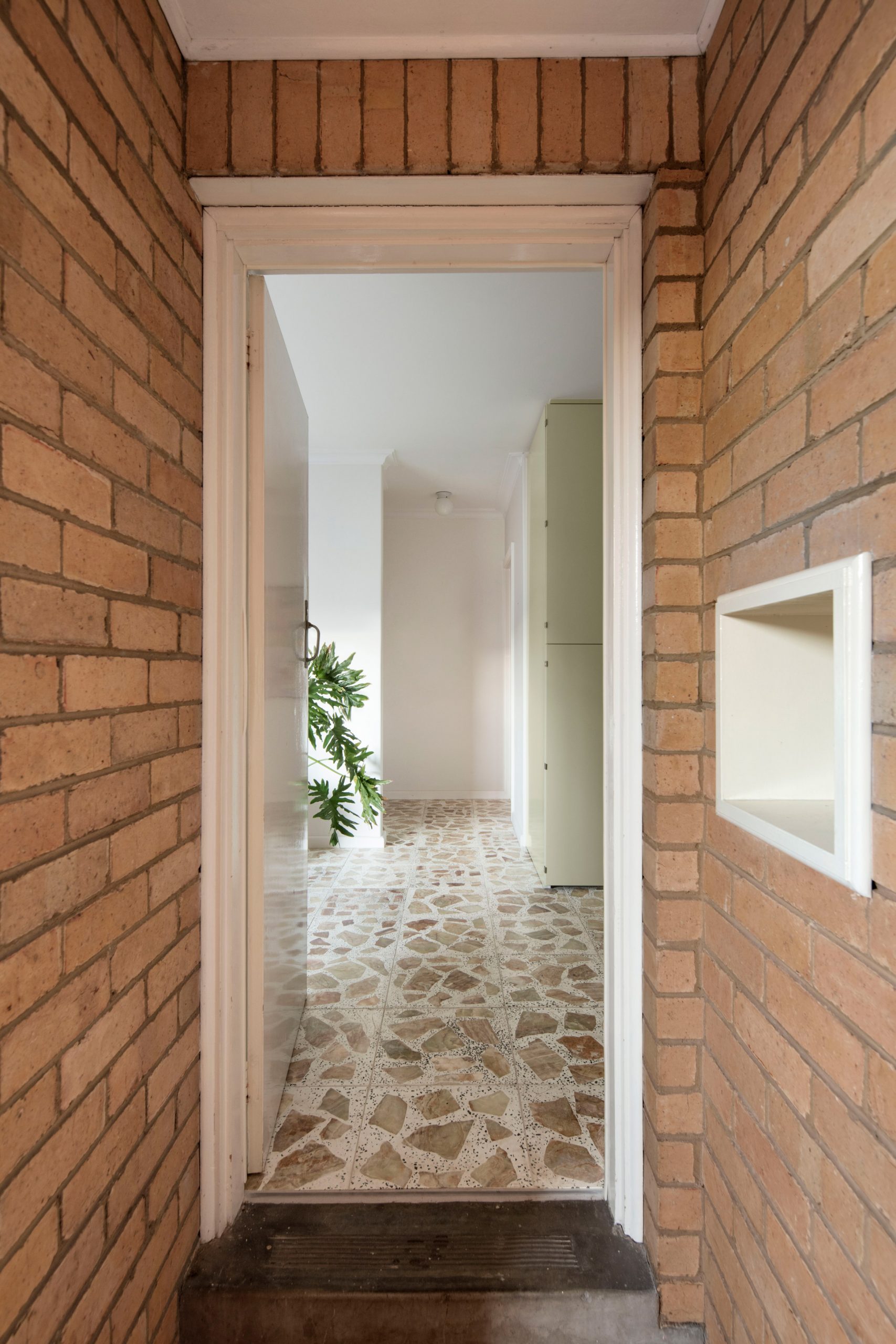 Brick walls and entrance of mid-century renovation by Murray Barker and Esther Stewart