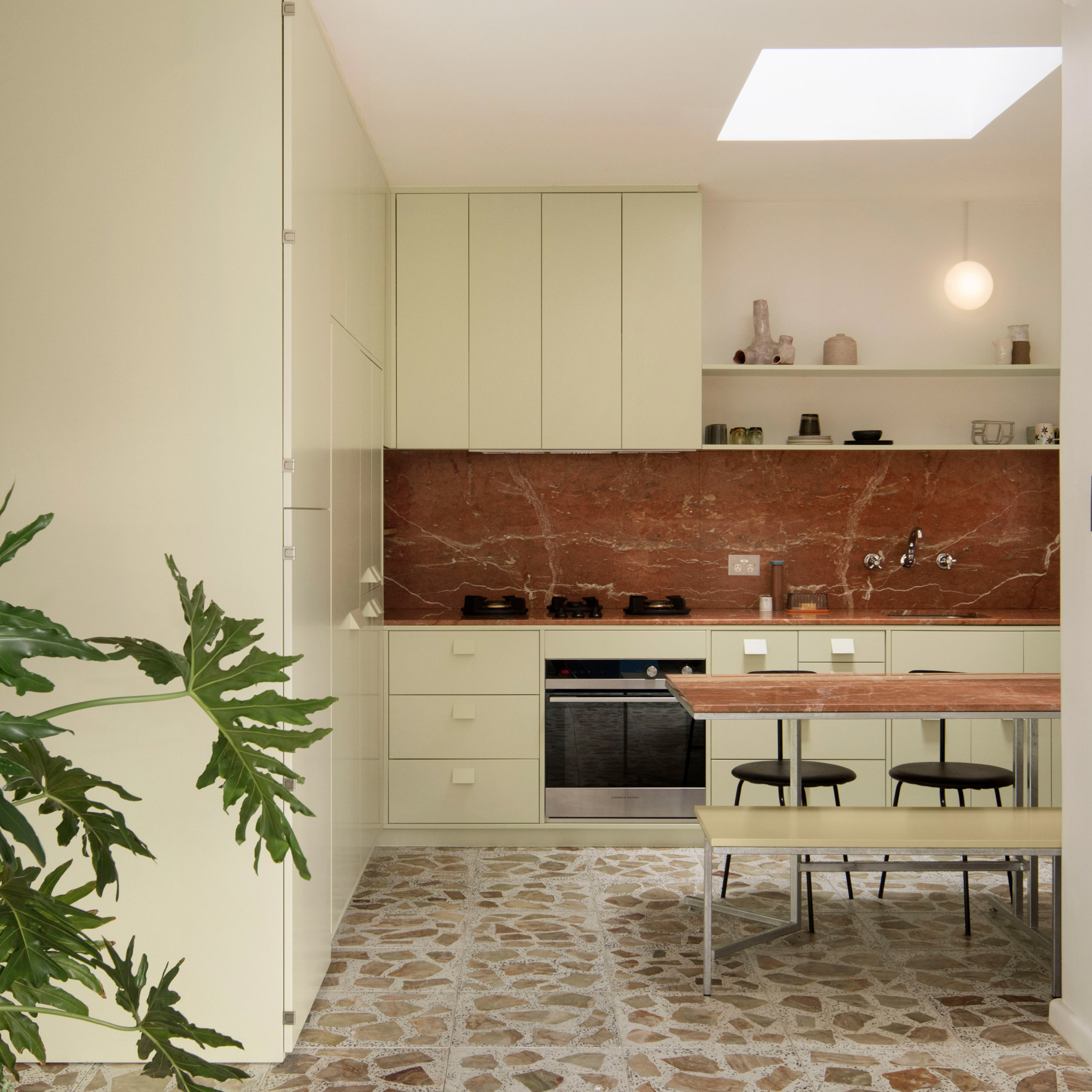 Pistachio green kitchen and terrazzo tiles in Brunswick apartment by Murray Barker and Esther Stewart
