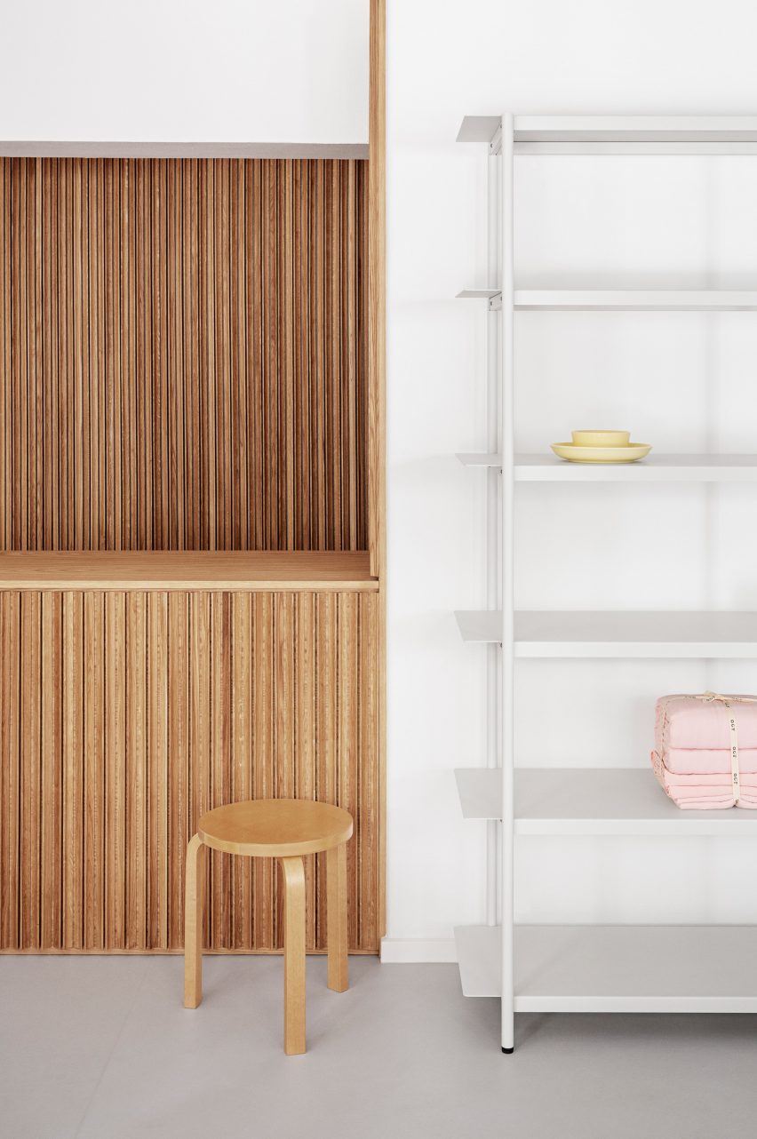 Wooden counter and white shelving in the OCE Copenhagen store interior by Aspekt Office
