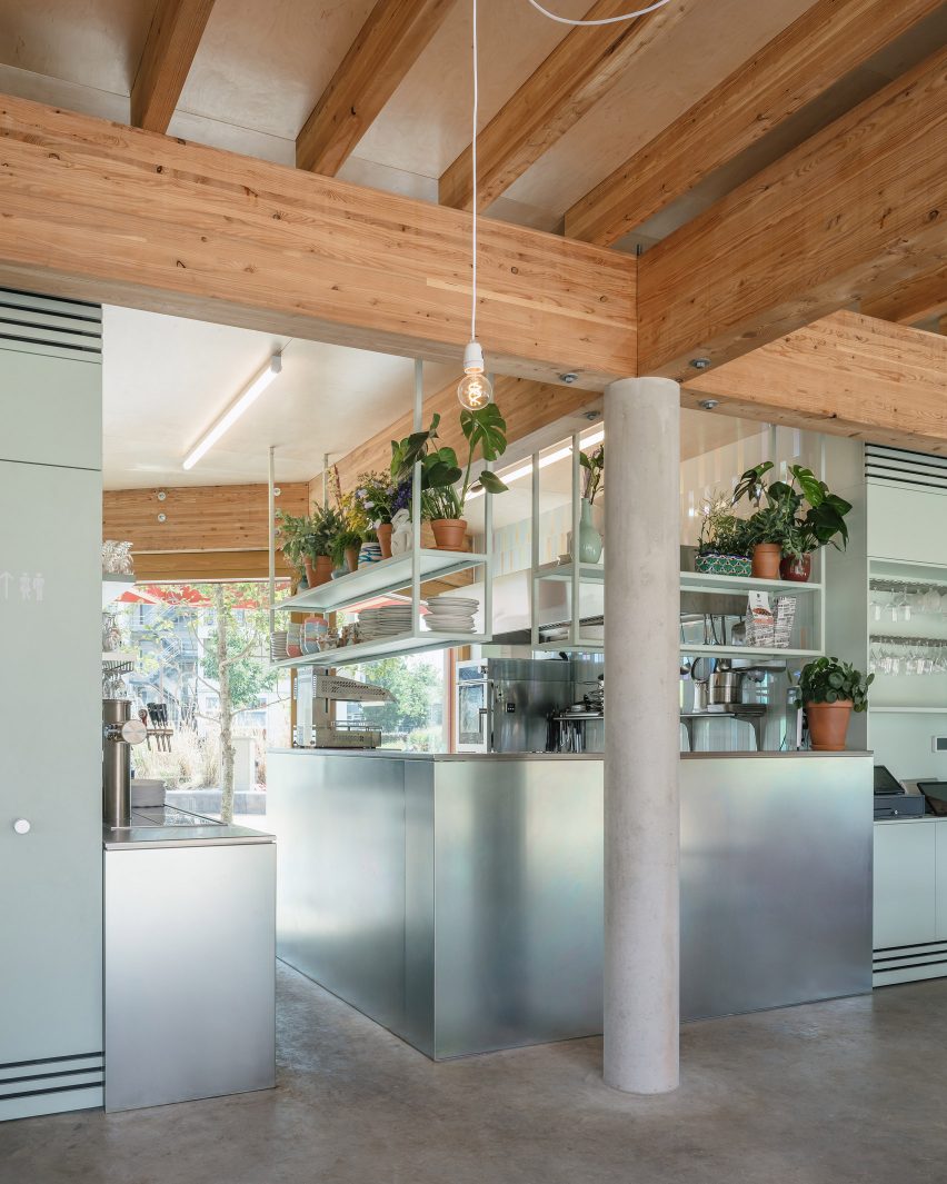 Steel and concrete restaurant interior with wood ceiling