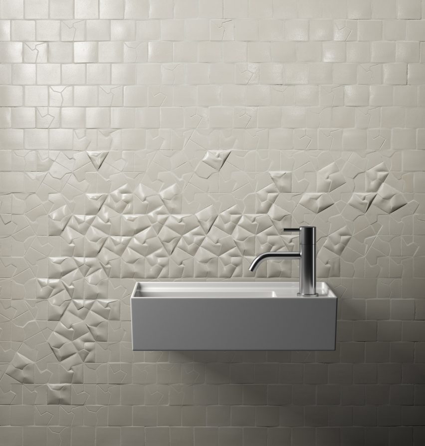 A white 3D-tiled bathroom wall