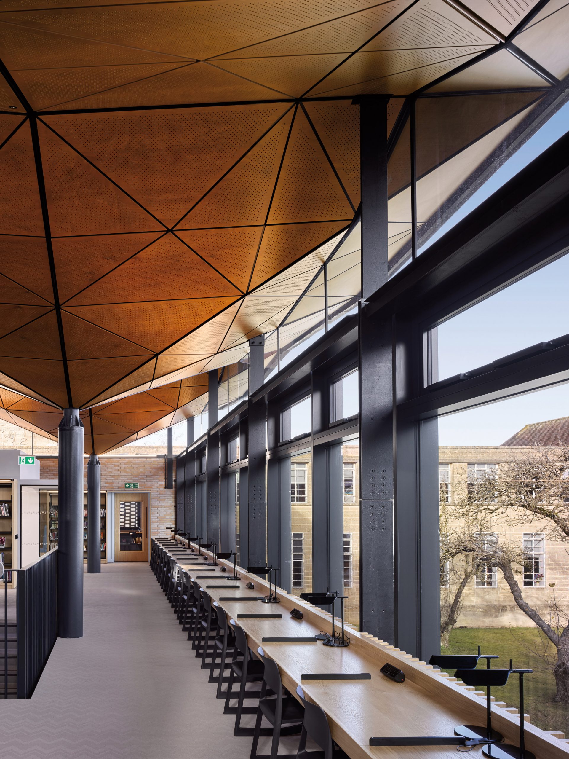 Geometric timber roof lines the interior of the design