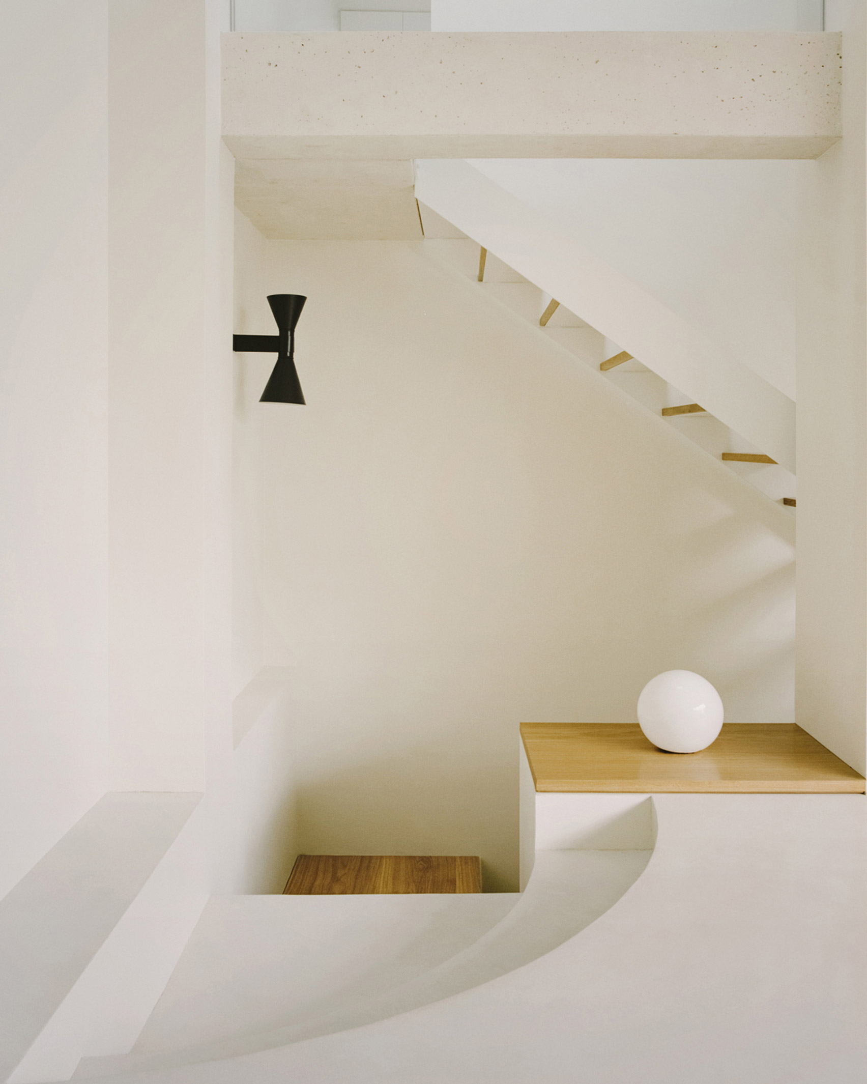 The white-walled stairwell of a Parisian townhouse by Clément Lesnoff-Rocard