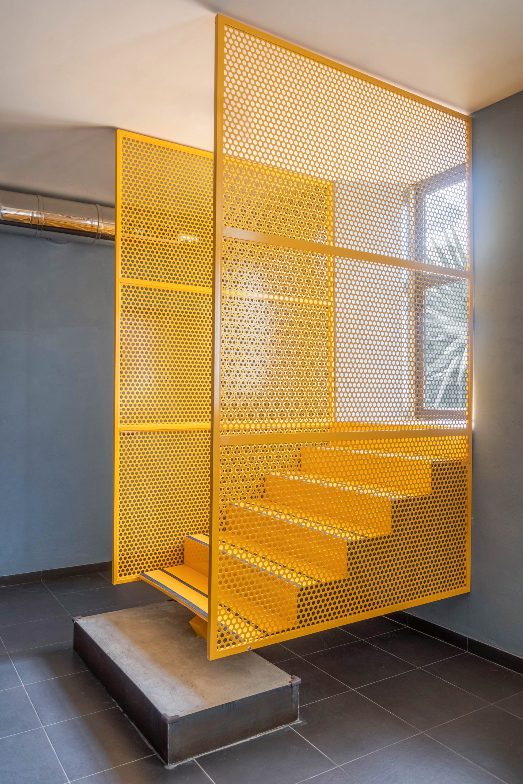 Yellow staircase in Tre De Tutto by Studio Tamat
