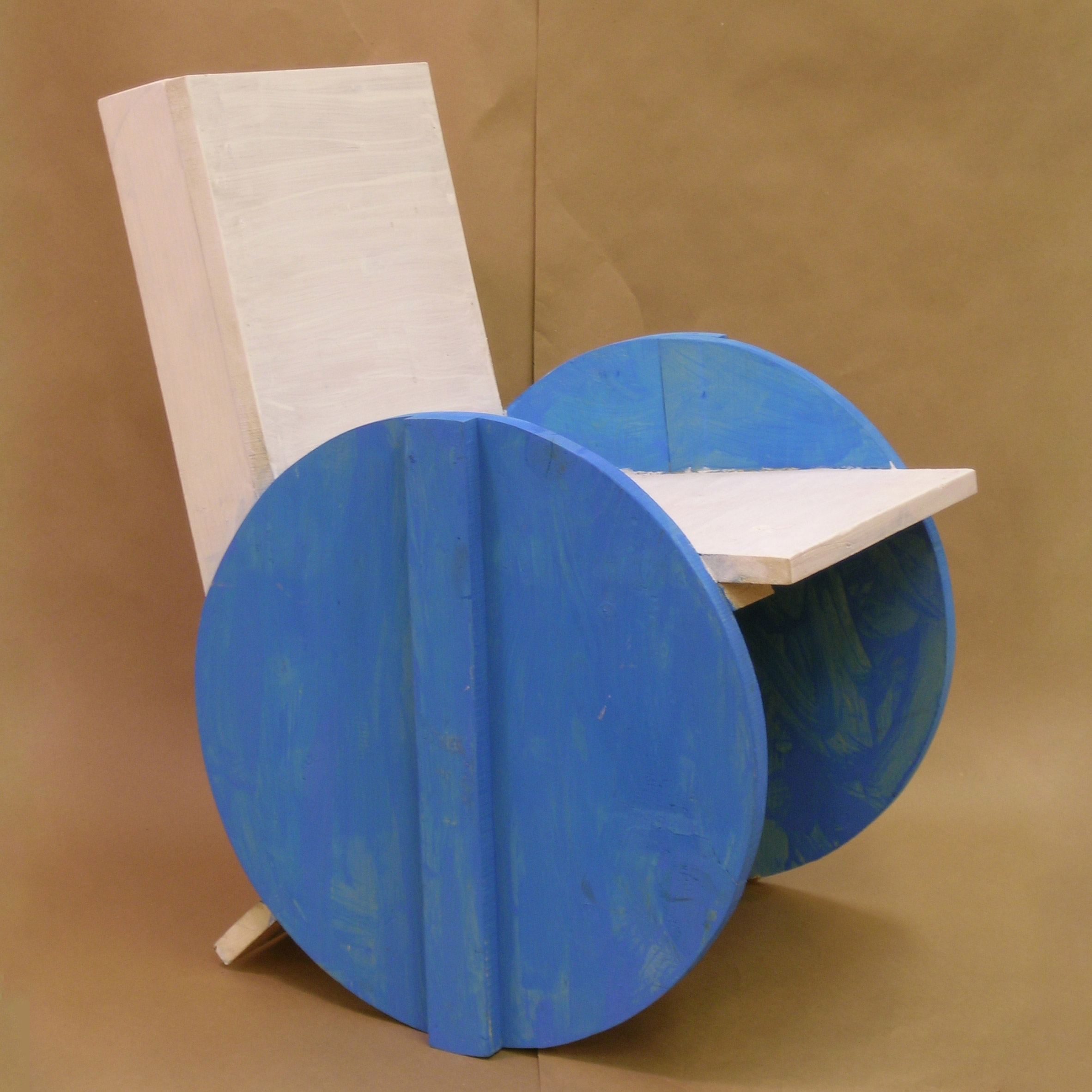 White chair with circular blue side panels from Grade Three Chairs project by Bruce Edelstein at Trinity School