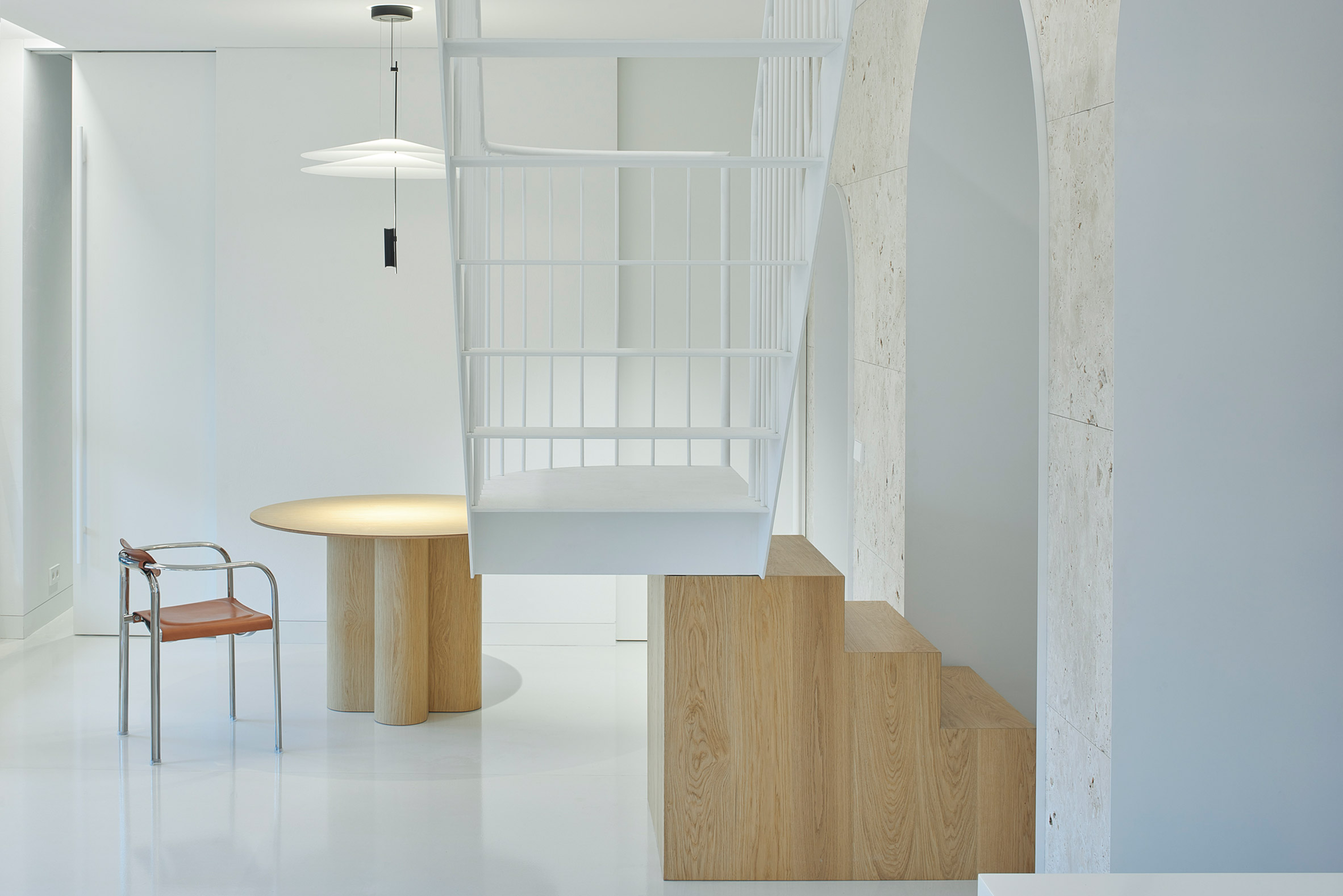Arched doorways and wood and steel staircase in Vilnius apartment