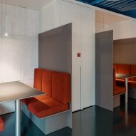 Seating in open plan spaces is upholstered in orange
