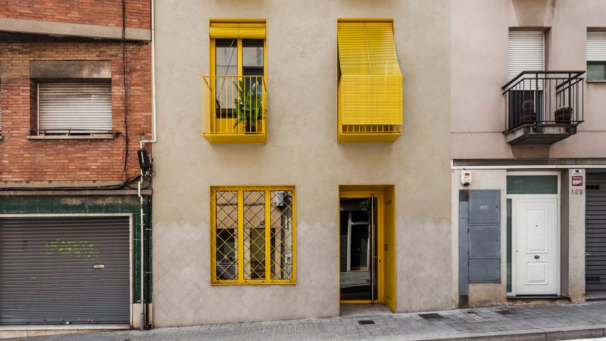 Barcelona apartment building with bright yellow balconies