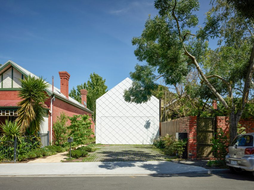 White shingled facade amongst residential buildings by Austin Maynard Architects