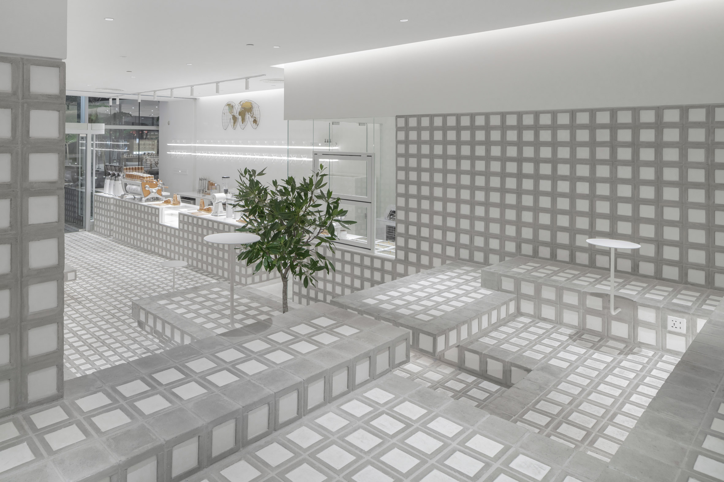 Grey and white seating area in cafe interior by Precht