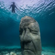 A snorkelers observing an underwater sculpture