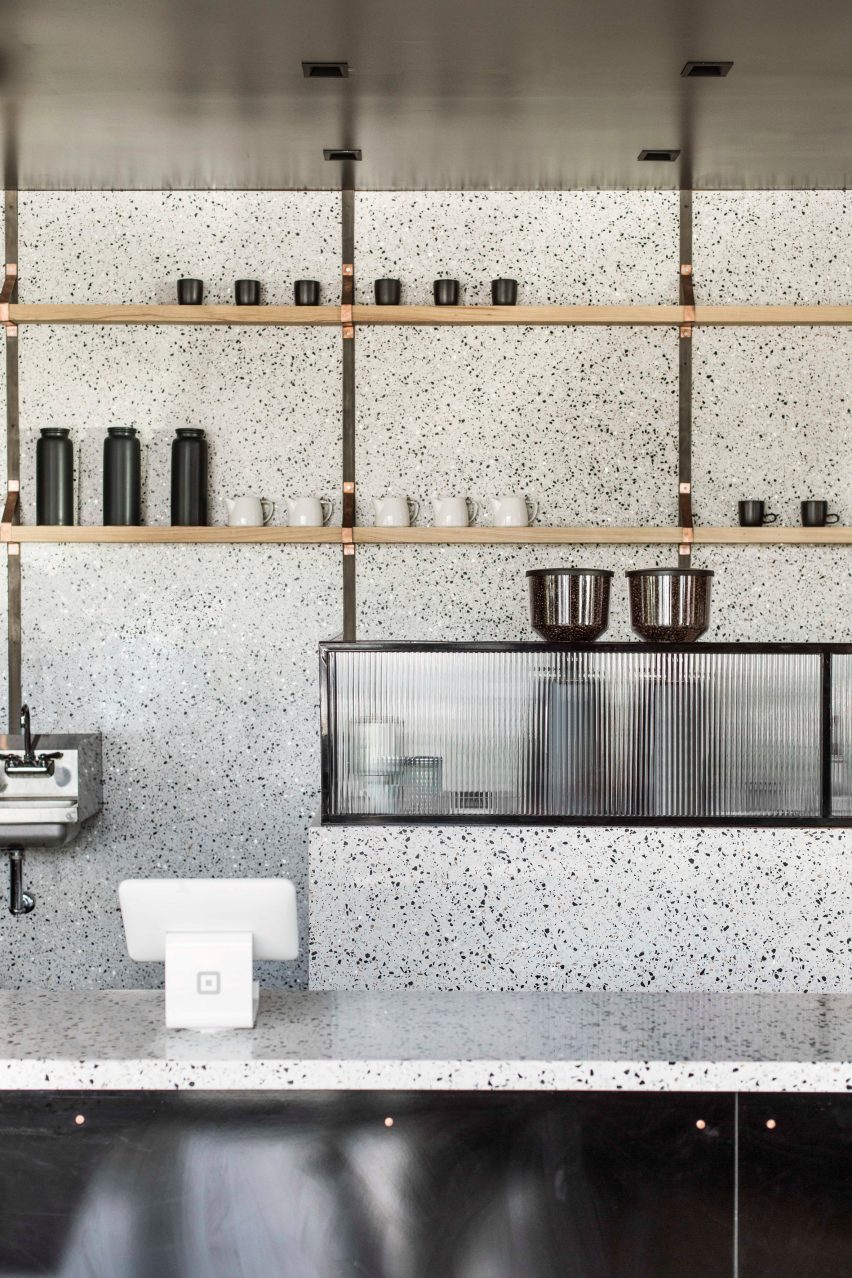 Terrazzo coffee bar with wooden shelves