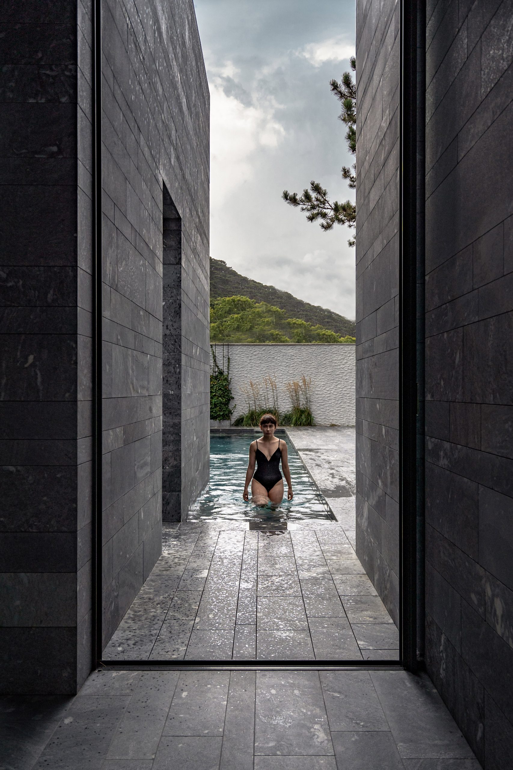 A view to a private swimming pool from a stone spa
