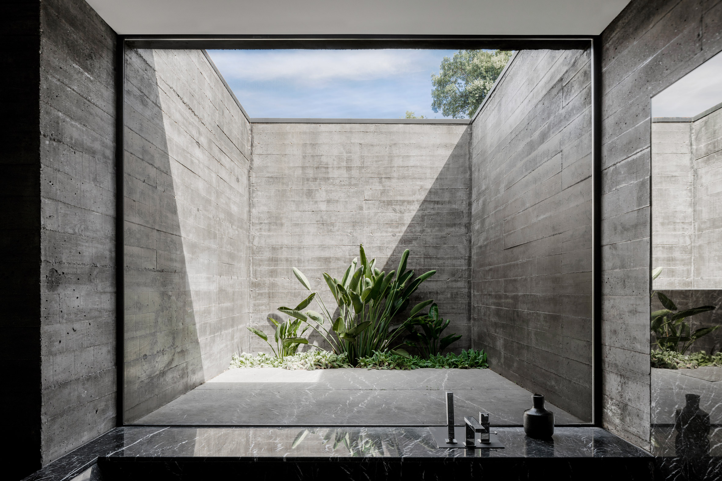 A courtyard enclosed by board-marked concrete 