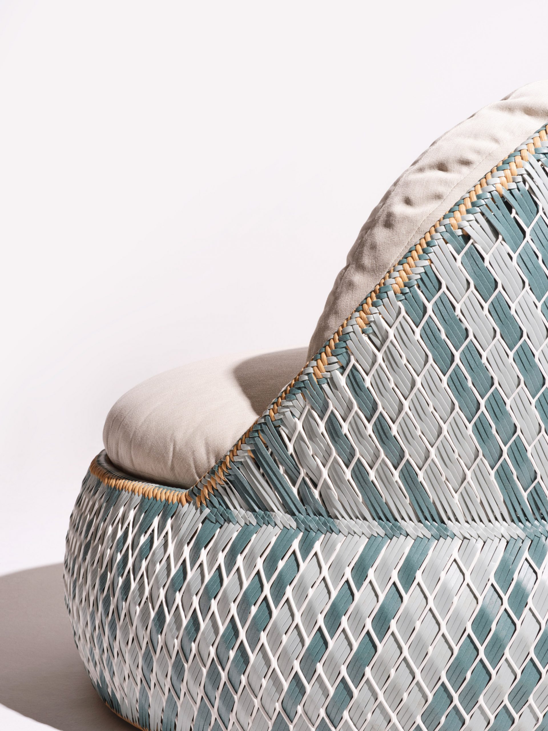 A close-up of a woven chair designed for Dedon