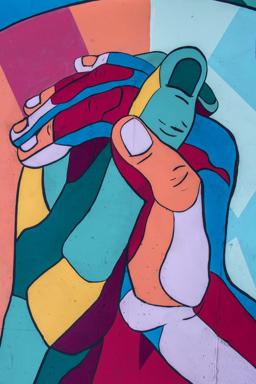 A colourful illustration of two hands