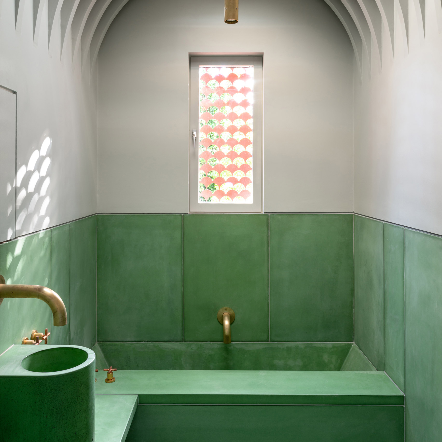 A green and white bathroom made from precast concrete