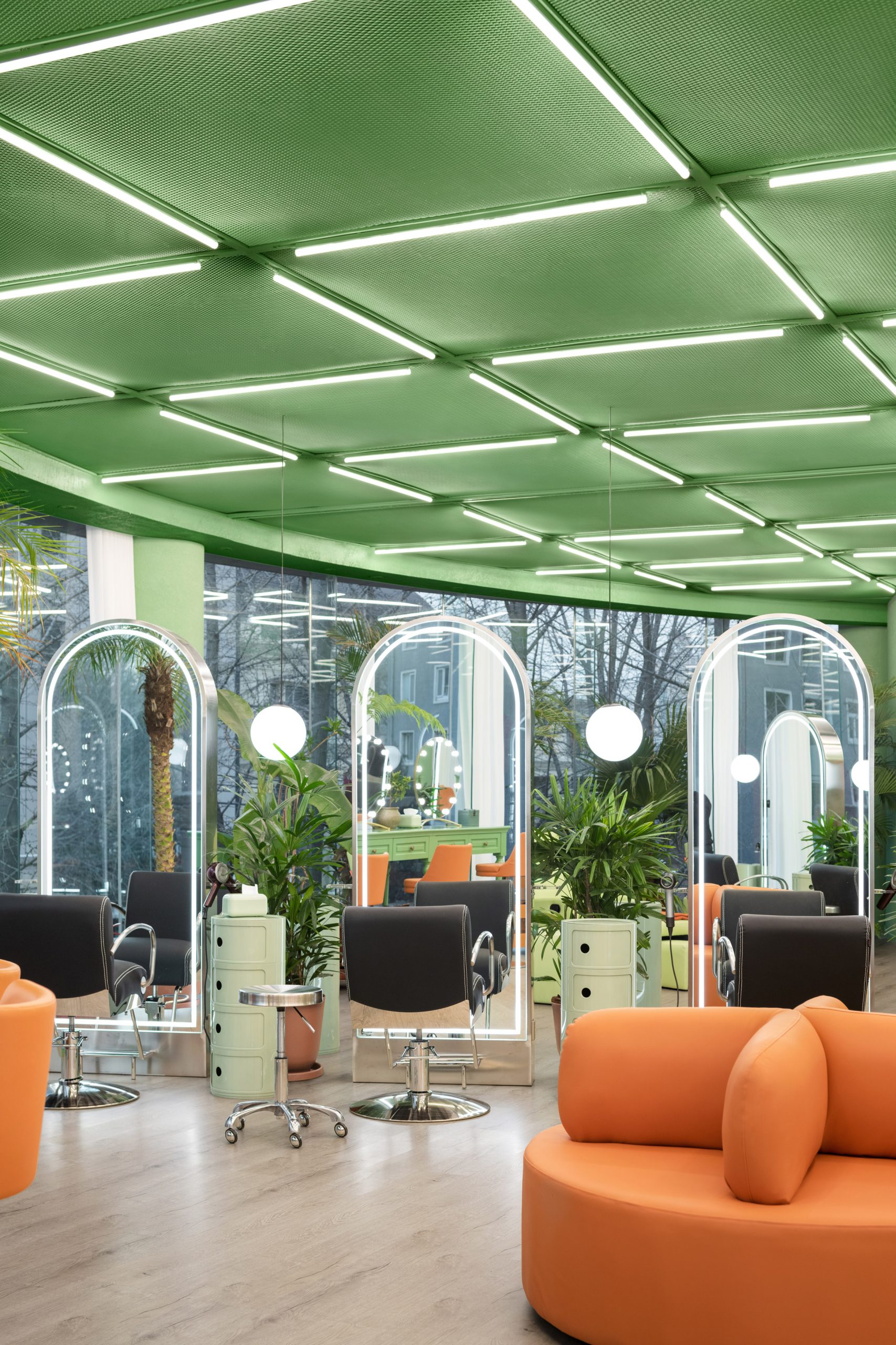 The ceiling is green and has strip lights by IS architecture and design