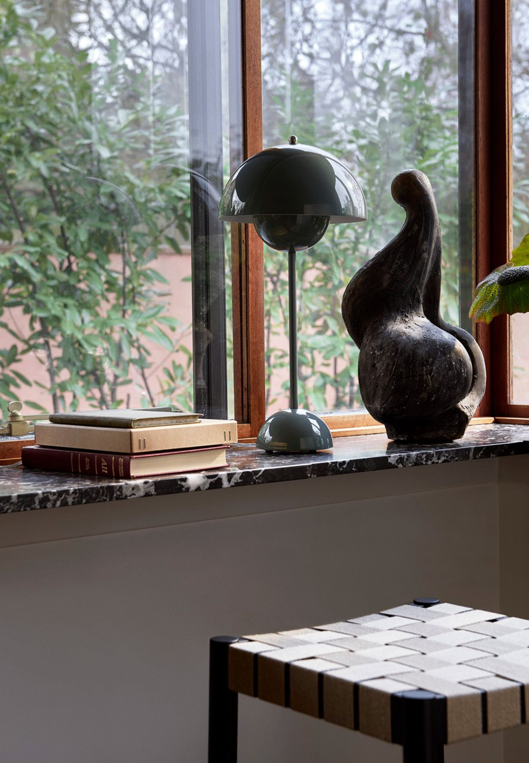 A windowsill with a Flowerpot lamp by &tradition