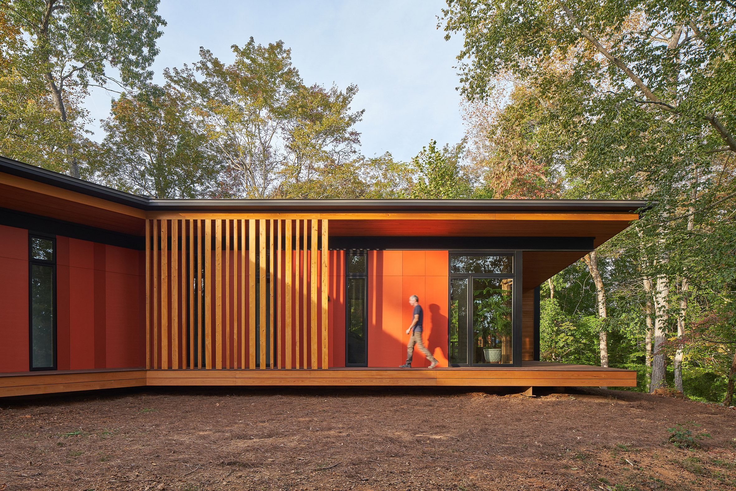 Orange siding of house by Sanders Pace