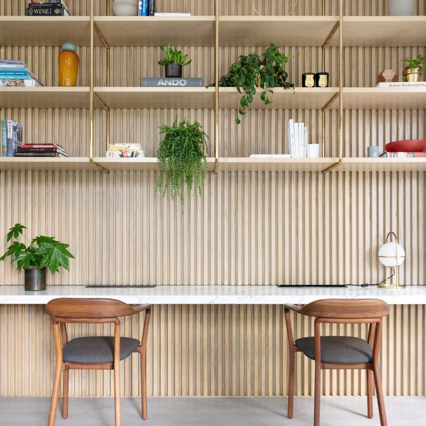 Home office with built-in shelving in Grosvenor Residence by Lim + Lu