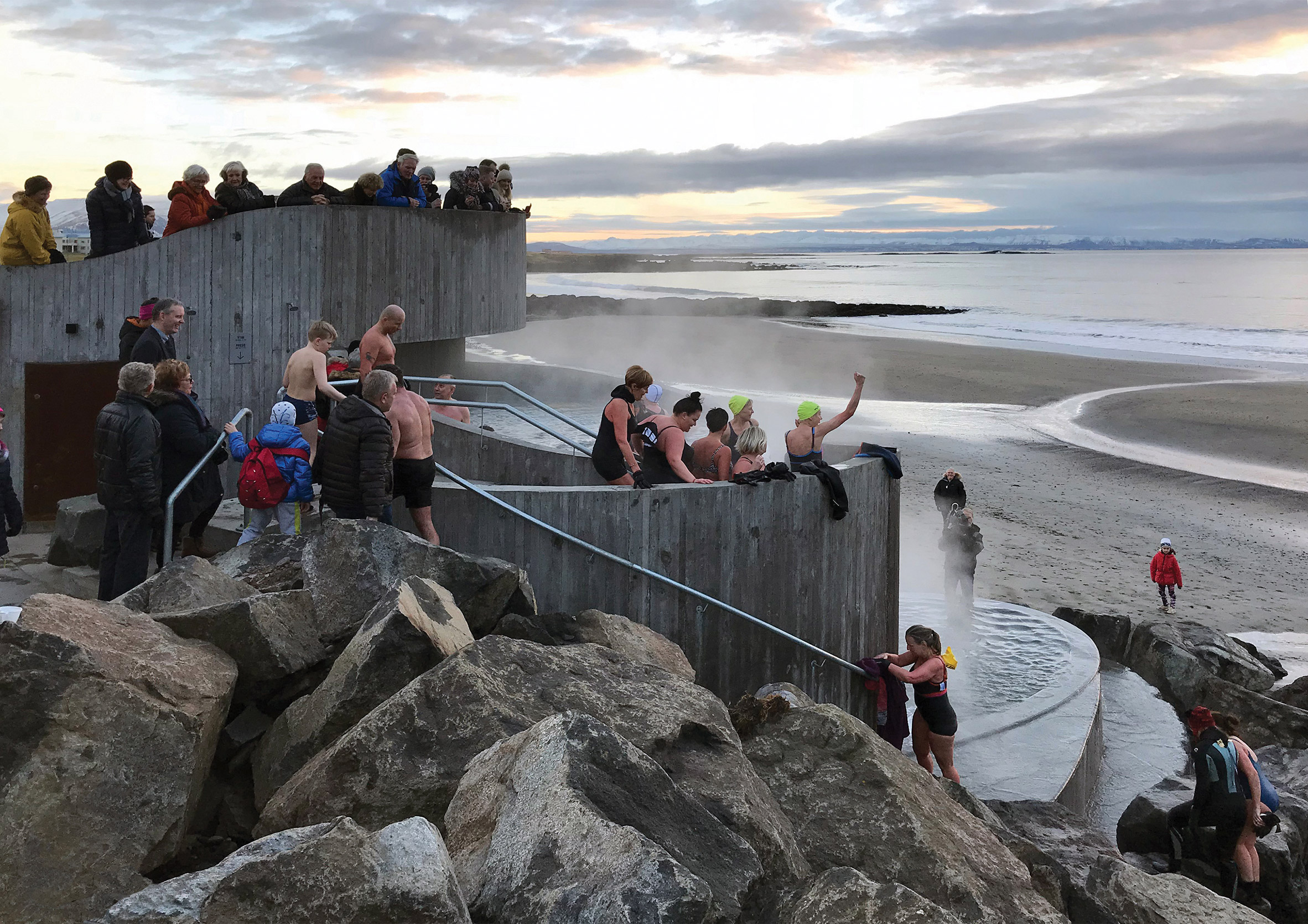 People at Guðlaug Baths by Basalt Architects