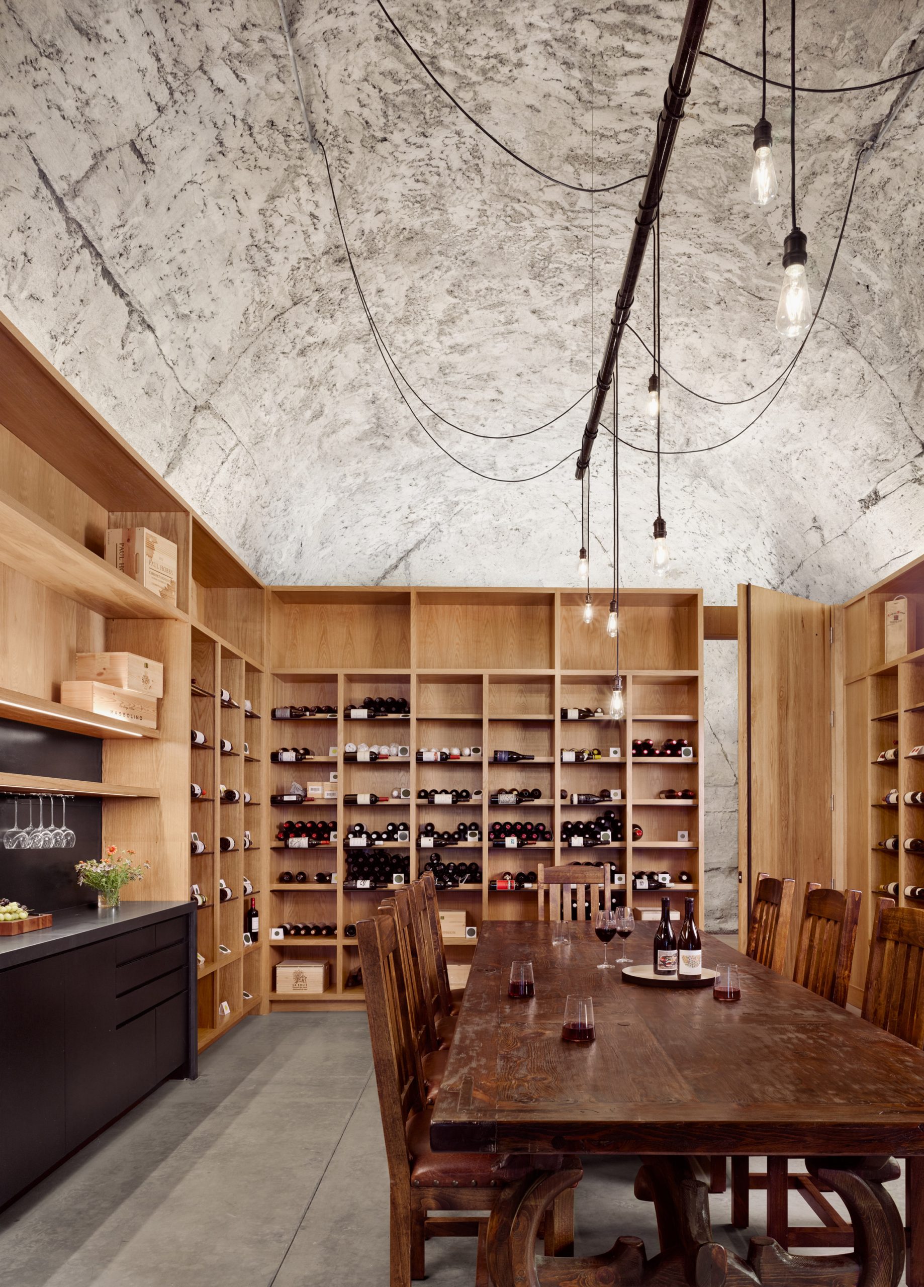Wine cellar with vaulted concrete ceilings by Clayton Korte