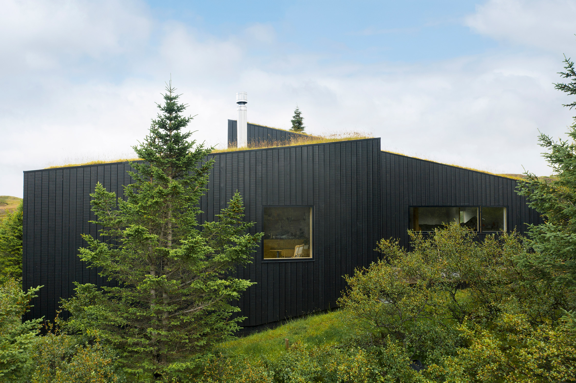 A holiday home with blackened-wood cladding