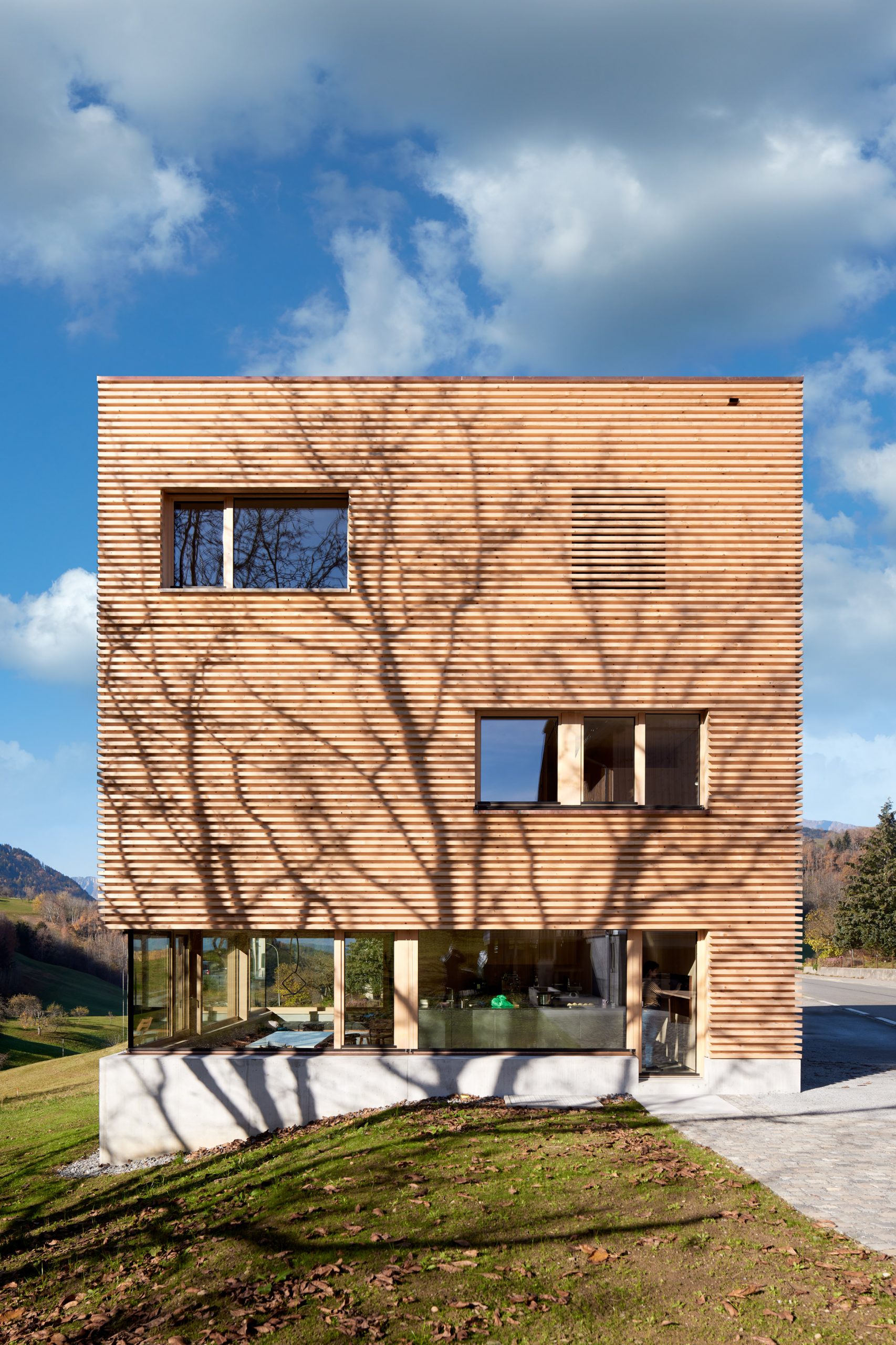 A timber-clad Austrian house with a concrete base