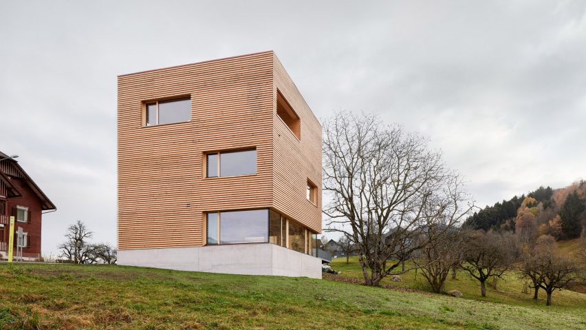 A square wood-clad house in an Austrian village