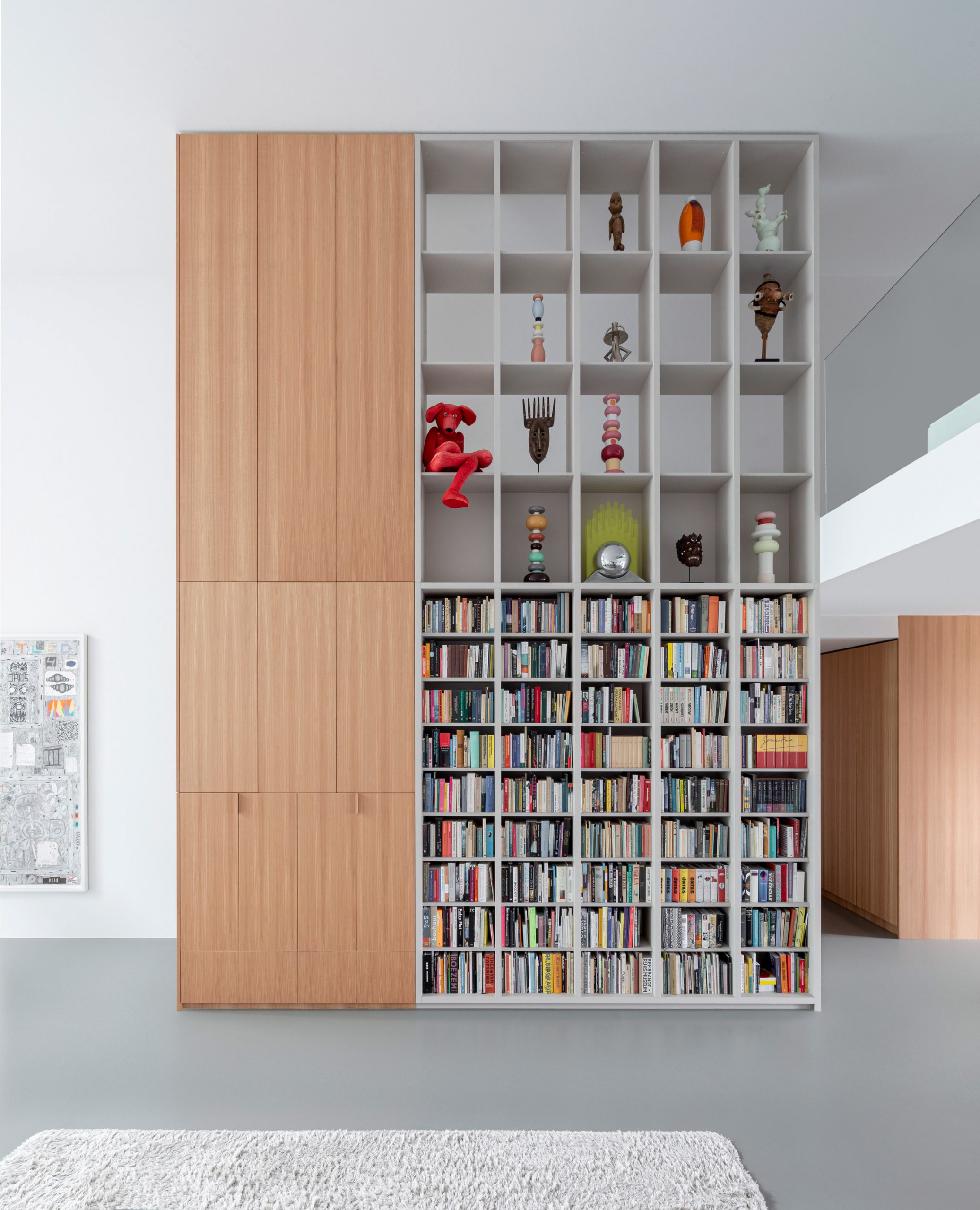 Built-in double-height storage shelves in Home of the Arts by i29