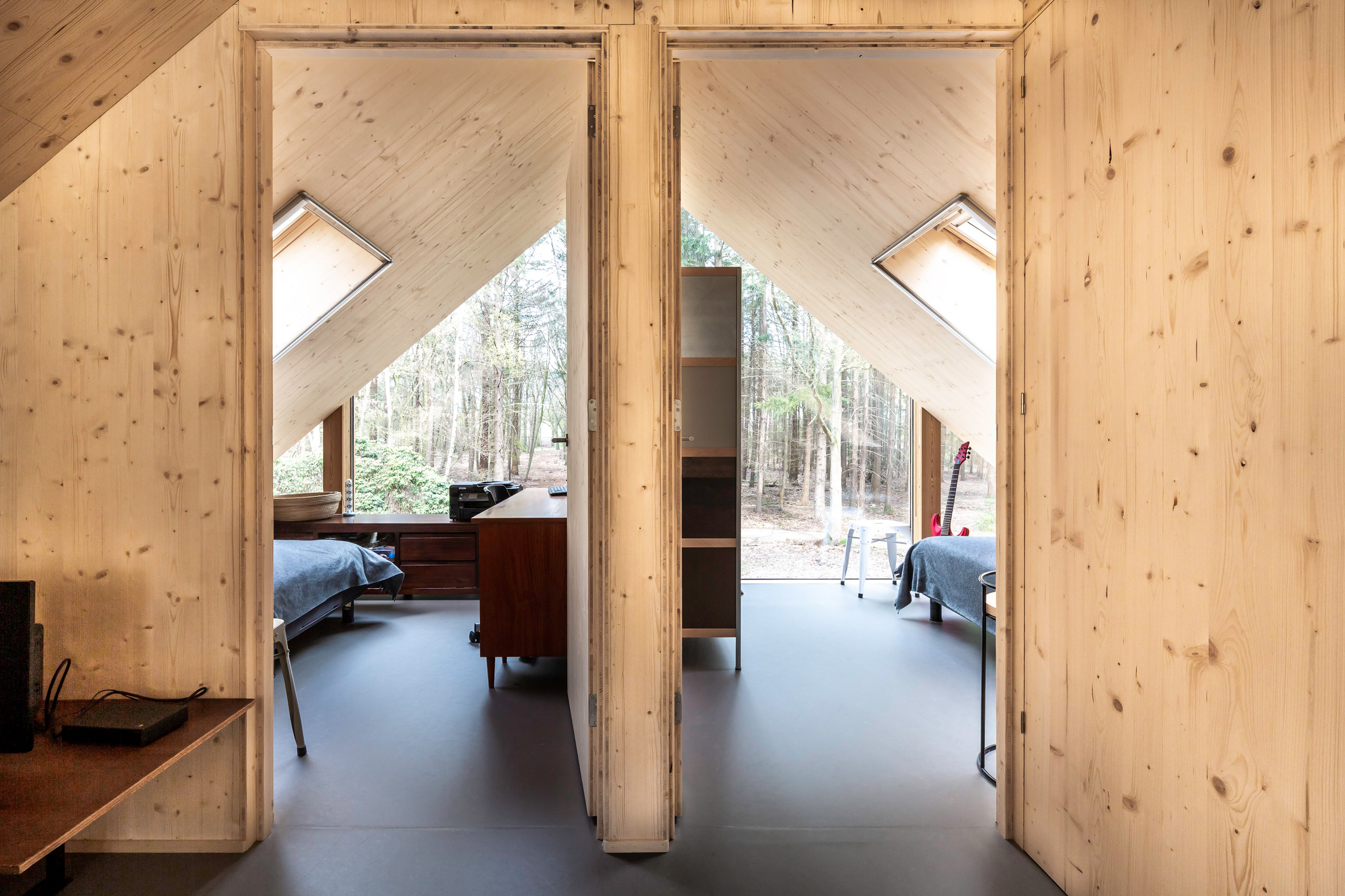 Wood-lined bedrooms in a forest cabin