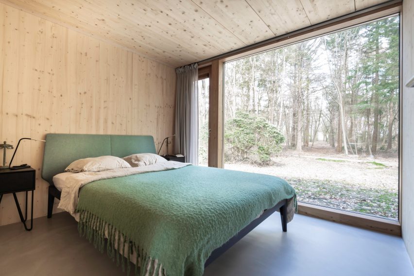 A bedroom with a floor-to-ceiling window