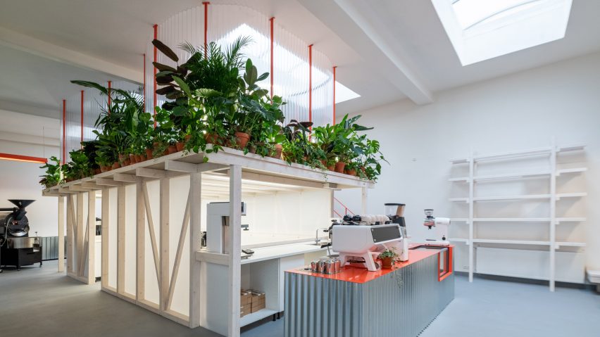 Plant-fringed mezzanine and corrugated metal counter of Grounds Coffee Hub
