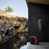 Hawaii house by Walker Warner Architects hugged by volcanic rock