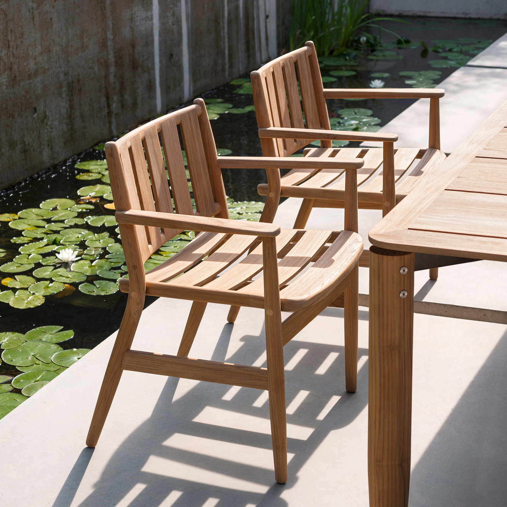 A pair of wooden outdoor dining chairs by Piero Lissoni