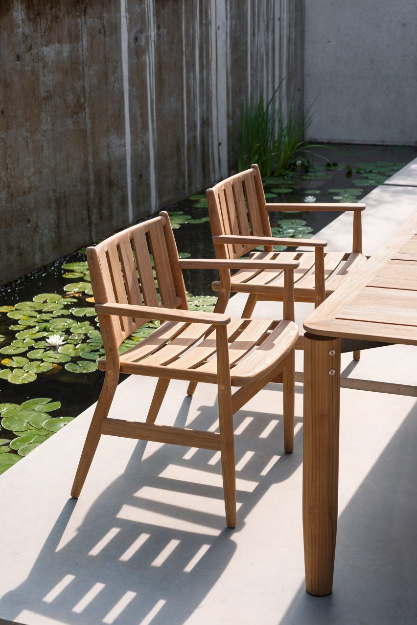 A pair of outdoor dining chairs made from teak