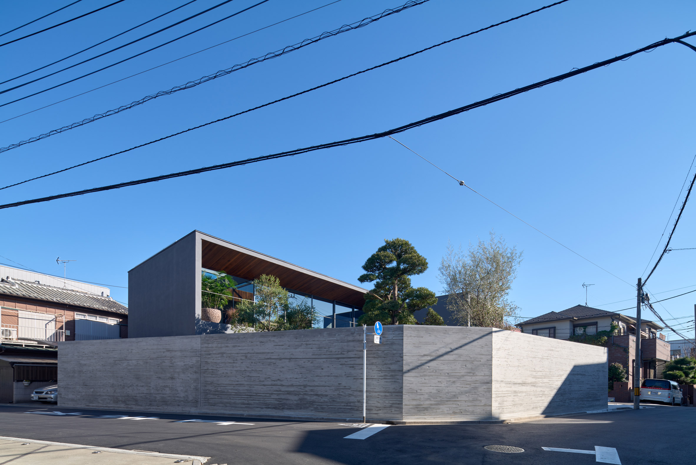 A concrete wall surrounds the home