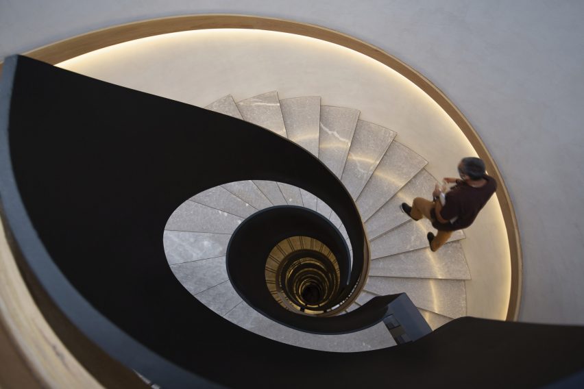 A spiral staircase with marble steps