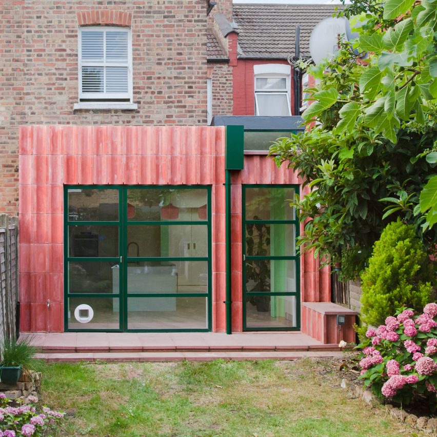 A kitchen extension clad in pink concrete