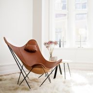 A butterfly chair made with brown leather