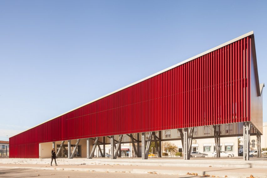 A pavilion clad in red aluminium slats