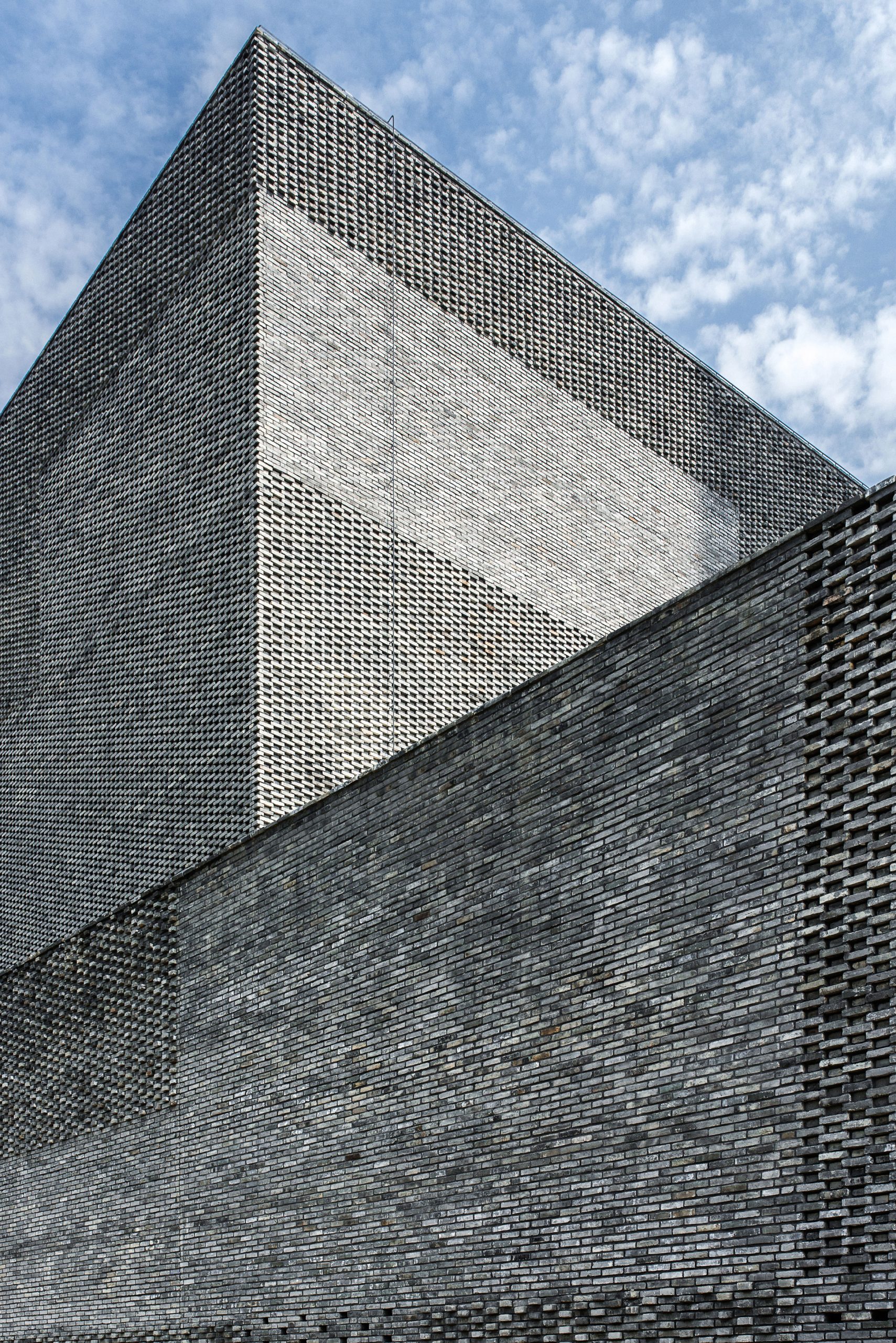 A tactile facade made from recycled grey bricks