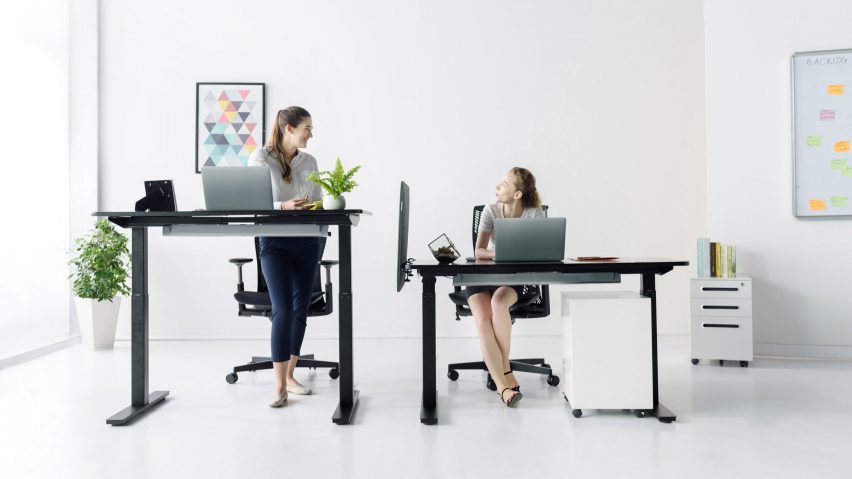 Black standing desk by Autonomous in the seated and standing position