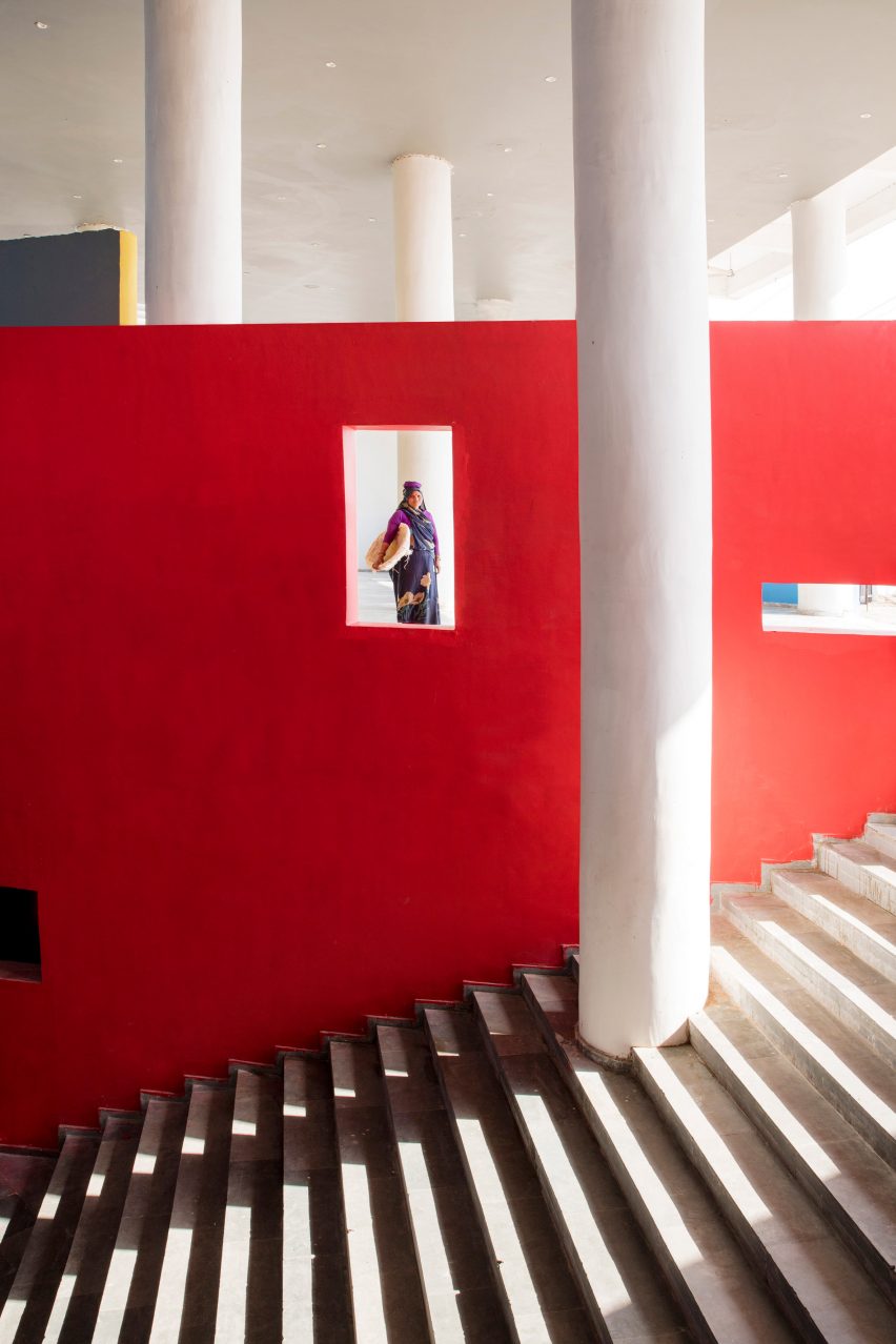 An external staircase lined with a bright red wall