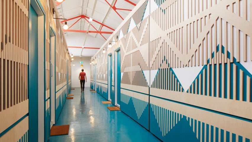 A colourful and patterned corridor made from plywood