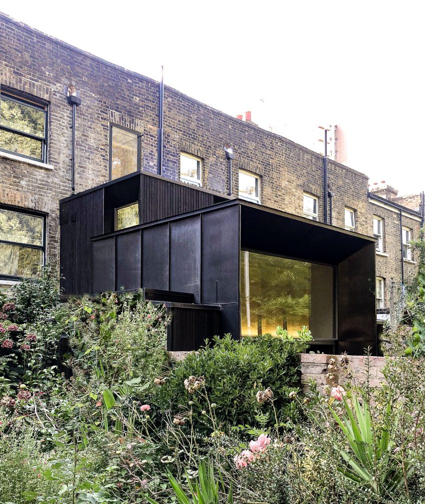 A photograph of a black cubic extension to terraced house